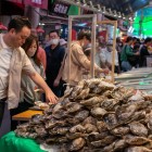 La Piața Omicho din Kanazawa, un stand oferă stridii proaspete din Marea Japoniei, servite cu condimente precum lămâie sau sos ponzu, pentru o experiență autentică.
