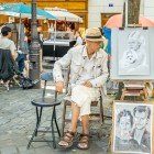 Un caricaturist stradal din Montmartre desenează turiștii cu trăsături rapide și ironice. Printre șevalete și culori, talentul său surprinde sufletul celui mai boem cartier al Parisului.