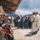 Indigeni mexicani adunați în piață poartă haine tradiționale tzotzil, pălării colorate, panglici vii și mantii din lână, într-o scenă autentică de cultură locală.