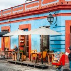 Cafenea locală pe o stradă tipică a orașului istoric de munte, cu arhitectură colonială vibrantă și străzi pavate cu piatră din sudul Mexicului.