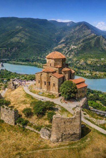 Interiorul Bisericii Jvari: un spațiu auster și sugestiv, cu cruci din lemn, icoane sacre și ziduri vechi de piatră ce păstrează secole de spiritualitate creștină georgiană.