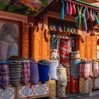 În souk-urile din Marrakech, magazinele și piețele expun mirodenii, țesături și produse artizanale tradiționale din Maroc.