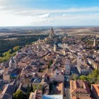 O panoramă aeriană dezvăluie farmecul Segoviei, unde străzile medievale, acoperișurile din teracotă și monumentele istorice alcătuiesc un peisaj unic, dominat de impunătoarea Catedrală.