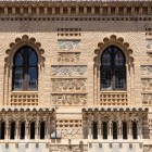 În vechiul cartier evreiesc din Toledo, Escuela de Artes y Oficios, proiectată de Arturo Mélida în 1882, îmbină forme neomudéjare, cărămidă, piatră și ferestre polilobate.