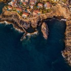 Văzută de sus, piscina naturală Isla Cangrejo se deschide printre rocile vulcanice din Santiago del Teide, protejată de un zid și înconjurată de albastrul profund al Atlanticului.