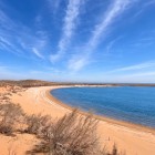 În deșertul Kyzylkum, Lacul Aydarkul întâlnește o plajă aurie întinsă: apele albastre și dunele presărate cu arbuști creează un peisaj natural surprinzător.
